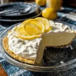 Chilled Lemonade Pie topped with whipped cream and lemon slices